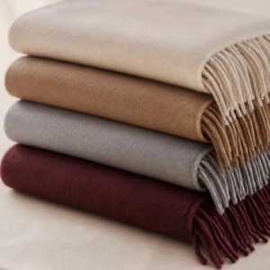 Plain pashmina shawls folded and stacked